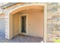 Stone archway frames the front door, creating a welcoming entrance at 2964 Gunnery Forge St, Las Vegas, NV 89156