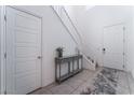 Bright entryway features tile floors, a console table, and a staircase leading to the second floor at 2964 Gunnery Forge St, Las Vegas, NV 89156