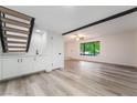 Open living space features a staircase, wet bar, and bright natural light at 3260 Longford Way, Las Vegas, NV 89121