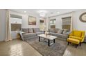 Bright and airy living room featuring modern furnishings, neutral tones, and ample natural light at 329 Brockbank Pl, Henderson, NV 89011