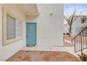 Welcoming condo entrance with a blue door, a small window and outdoor space at 3318 N Decatur Blvd # 1061, Las Vegas, NV 89130