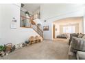 Spacious living room with staircase, plush carpeting, and a connecting sitting room at 3786 Port Ritchey St, Las Vegas, NV 89147