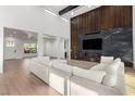Open living room with a modern fireplace, wood floors and high ceilings at 5725 El Royale Ct, Las Vegas, NV 89149