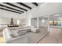 Spacious living room featuring an open floor plan, high ceilings, and white color palette at 5725 El Royale Ct, Las Vegas, NV 89149