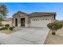 Inviting single-story home with a spacious driveway and well-manicured desert landscaping at 5833 Craigmore Ln, North Las Vegas, NV 89031