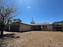 Single-story home featuring a two-car garage and low desert landscaping at 613 Buchanan Ave, Henderson, NV 89015