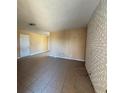 Spacious living room with tile flooring and a white brick accent wall at 613 Buchanan Ave, Henderson, NV 89015
