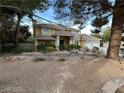 Charming home with a well-maintained front yard, mature trees, and a welcoming entrance creating a warm curb appeal at 8138 Yucca Springs Dr, Las Vegas, NV 89129
