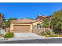 Attractive single-story residence featuring a two-car garage, xeriscaping, and stone accents at 8247 Oasis Bloom St, North Las Vegas, NV 89085