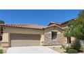 Home exterior features a two-car garage, stone accents, and a well-maintained yard, offering a blend of style and functionality at 8247 Oasis Bloom St, North Las Vegas, NV 89085