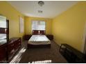 Simple bedroom featuring neutral carpet and walls and matching wood furniture and full-sized bed at 8325 Aspen Village St, Las Vegas, NV 89113