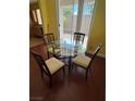 Cozy dining area with a glass table and seating for four at 8325 Aspen Village St, Las Vegas, NV 89113