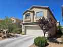 View of home's exterior featuring an attached two-car garage and mature landscaping at 8345 Mozley Park St, Las Vegas, NV 89113
