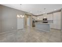 Open-concept kitchen featuring white cabinets, granite countertops, and stainless steel appliances at 8562 Insignia Ave # 102, Las Vegas, NV 89178