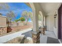 Welcoming covered porch with stone-clad columns and a view of the landscaped walkway at 8562 Insignia Ave # 102, Las Vegas, NV 89178