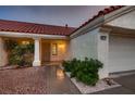 Inviting front entrance with desert landscaping and secure screen door at 8613 Linderwood Dr, Las Vegas, NV 89134
