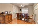 Inviting dining room with a wooden table, seating for eight, and a window, perfect for gatherings at 9065 W Torino Ave, Las Vegas, NV 89148