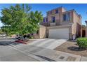 Two-story house showcasing an attached two-car garage, ample driveway, and manicured landscaping at 9065 W Torino Ave, Las Vegas, NV 89148