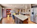 Open-concept kitchen flows into the spacious living area, with stainless steel refrigerator at 9065 W Torino Ave, Las Vegas, NV 89148