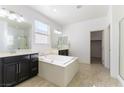A bright bathroom with dual sinks, a soaking tub, and a separate glass shower at 10742 Cowlite Ave, Las Vegas, NV 89166