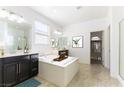 Bright bathroom with a soaking tub, dual vanities, and ample natural light from a window, plus a walk-in closet at 10742 Cowlite Ave, Las Vegas, NV 89166