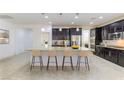 Spacious kitchen with an island, granite countertops, stainless steel appliances, and pendant lighting over the island at 10742 Cowlite Ave, Las Vegas, NV 89166