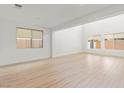 Spacious living room with hardwood floors and natural light, perfect for relaxing and entertaining at 10851 Hanwicke Harbor Ave, Las Vegas, NV 89166