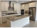 Modern kitchen featuring stainless steel appliances, granite countertops, and a central island at 11427 Ethereal Landing Ave, Las Vegas, NV 89138