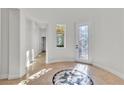 Bright foyer with decorative tiled floor, high ceilings, and ornate glass entry door at 11621 La Mirago Pl, Las Vegas, NV 89138