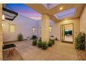 Picturesque courtyard with a stone pillar, skylight, and view into the home at 11895 Skyline Arch Ct, Las Vegas, NV 89138