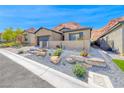 Charming desert landscaping enhances this attractive single-story home's curb appeal at 125 Mirage View Dr, Henderson, NV 89011