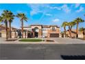 A beautiful two-story home showcasing the well-manicured yard with an inviting entrance and palm trees at 1316 Eagle Meadow Ct, Las Vegas, NV 89123