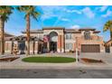 Attractive two-story home featuring stone accents, a circular lawn, and well-maintained landscaping at 1316 Eagle Meadow Ct, Las Vegas, NV 89123