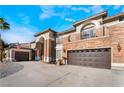 Spacious three-car garage showcasing the home's beautiful stone and stucco exterior and driveway at 1316 Eagle Meadow Ct, Las Vegas, NV 89123