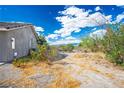 Expansive backyard featuring desert landscaping, a chain-link fence, and ample space for outdoor activities at 1351 Fawn St, Pahrump, NV 89048