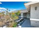 Inviting front entrance with covered porch, secure gate, xeriscape and textured concrete path at 1351 Fawn St, Pahrump, NV 89048