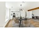 Dining area adjacent to a modern kitchen with white cabinets and stainless steel appliances at 1724 Navajo Lake Way, Las Vegas, NV 89128