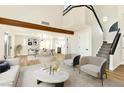 Open concept living space with modern decor, staircase and dining area with natural lighting at 1724 Navajo Lake Way, Las Vegas, NV 89128