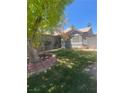 The front of the home has a well-maintained lawn and flowerbeds at 1841 Skywood Way, Las Vegas, NV 89142