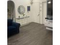 Living room featuring wood-look vinyl flooring and a console table at 1841 Skywood Way, Las Vegas, NV 89142