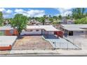 Aerial view of a single-story home featuring a carport, fresh exterior paint, and a secure gated front yard at 2016 Linden Ave, Las Vegas, NV 89101