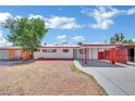 Charming single-story home featuring a carport, fresh exterior paint, and a secure gated front yard at 2016 Linden Ave, Las Vegas, NV 89101
