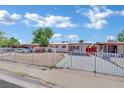 Charming single-story home featuring a carport, fresh exterior paint, and a secure gated front yard at 2016 Linden Ave, Las Vegas, NV 89101