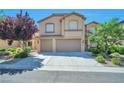 Inviting two-story home with a neutral facade, two-car garage, and well-maintained front yard at 2189 De Narvik Dr, Henderson, NV 89044