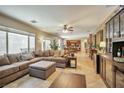 Spacious living room with tile floors, large windows, and a comfortable seating area at 2189 De Narvik Dr, Henderson, NV 89044