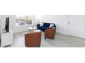 Comfortable living room featuring a blue sofa, modern tables, and light wood-style flooring at 2300 E Silverado Ranch Blvd # 1165, Las Vegas, NV 89183