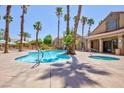 Resort-style pool area with towering palm trees and comfortable seating, perfect for relaxation at 2300 E Silverado Ranch Blvd # 1165, Las Vegas, NV 89183