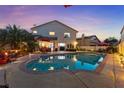 Backyard oasis featuring a sparkling pool, manicured landscaping, and patio furniture at 2639 Regency Cove Ct, Las Vegas, NV 89121
