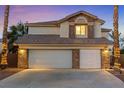 Charming two-story home featuring a three-car garage, stone accents, and manicured landscaping at 2639 Regency Cove Ct, Las Vegas, NV 89121