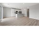 Bright, open-concept kitchen featuring white cabinets, stainless appliances, and a center island with a breakfast bar at 3224 Lahontan St, North Las Vegas, NV 89032
